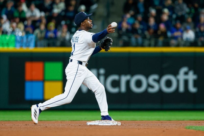 Apr 8, 2025; Seattle, Washington, USA; Seattle Mariners second baseman Ryan Bliss (1) turns a double play against the Houston Astros during the sixth inning at T-Mobile Park. Mandatory Credit: Joe Nicholson-Imagn Images