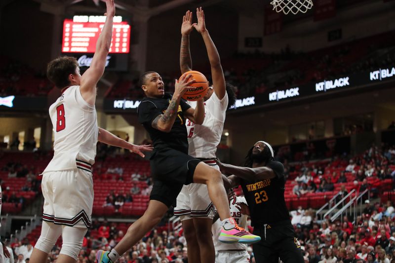 Dec 28, 2025; Lubbock, Texas, USA;  Winthrop Eagles guard Isaiah Wilson (1) drives to the basket between Texas Tech Red Raiders guard Nolan Groves (8) and forward Leon Horner (6) in the second half at United Supermarkets Arena. Mandatory Credit: Michael C. Johnson-Imagn Images