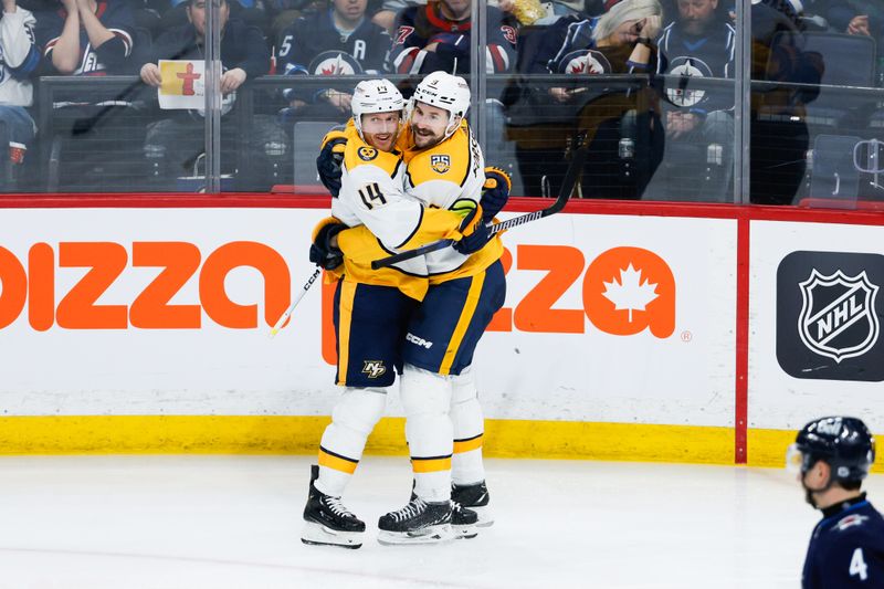 Mar 13, 2024; Winnipeg, Manitoba, CAN; Nashville Predators forward Filip Forsberg (9) is congratulated by Nashville Predators forward Gustav Nyquist (14) on his goal against the Winnipeg Jets during the third period at Canada Life Centre. Mandatory Credit: Terrence Lee-USA TODAY Sports