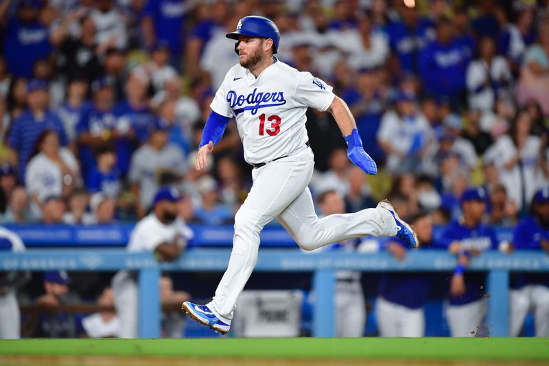 Sep 12, 2023; Los Angeles, California, USA;  Los Angeles Dodgers third baseman Max Muncy (13) runs home to score against the San Diego Padres during the seventh inning at Dodger Stadium. Mandatory Credit: Gary A. Vasquez-USA TODAY Sports