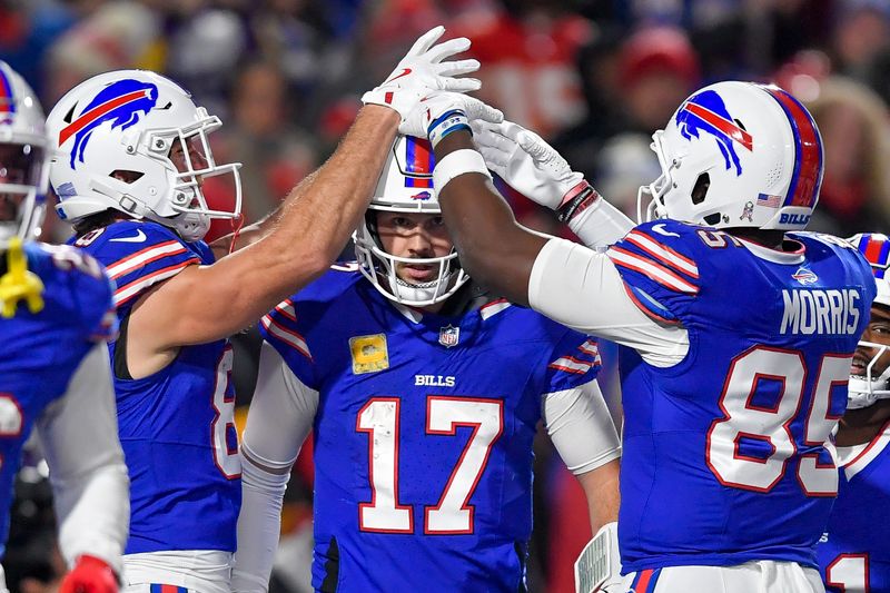 Buffalo Bills quarterback Josh Allen (17) celebrates with tight ends Dawson Knox, left, and Quintin Morris after scoring during the second half of an NFL football game against the Kansas City Chiefs in Orchard Park, N.Y., Sunday, Nov. 17, 2024. (AP Photo/Adrian Kraus)