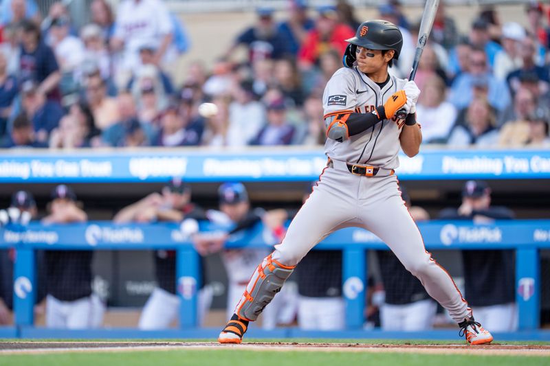 May 10, 2025; Minneapolis, Minnesota, USA; San Francisco Giants outfielder Jung Hoo Lee (51) is brushed back by a pitch from Minnesota Twins starting pitcher Joe Ryan (41) in the first inning at Target Field. Mandatory Credit: Matt Blewett-Imagn Images