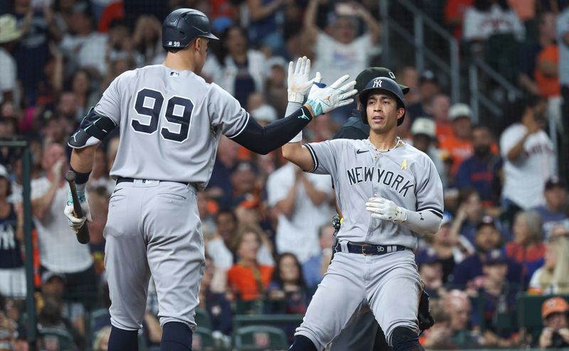 Sep 3, 2023; Houston, Texas, USA; New York Yankees right fielder Oswaldo Cabrera (95) celebrates with designated hitter Aaron Judge (99) after scoring a run during the sixth inning against the Houston Astros at Minute Maid Park. Mandatory Credit: Troy Taormina-USA TODAY Sports