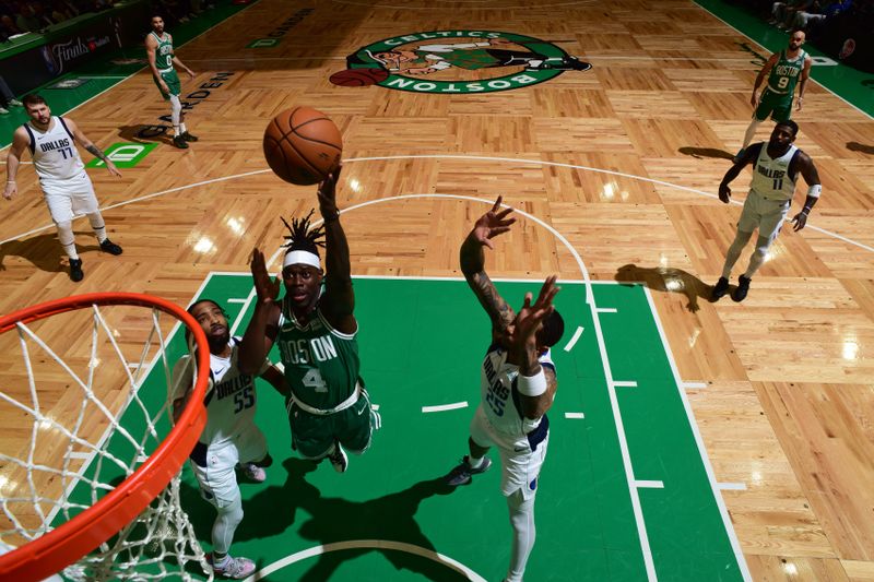 BOSTON, MA - JUNE 17: Jrue Holiday #4 of the Boston Celtics shoots the ball during the game against the Dallas Mavericks during Game 5 of the 2024 NBA Finals on June 17, 2024 at the TD Garden in Boston, Massachusetts. NOTE TO USER: User expressly acknowledges and agrees that, by downloading and or using this photograph, User is consenting to the terms and conditions of the Getty Images License Agreement. Mandatory Copyright Notice: Copyright 2024 NBAE  (Photo by Garrett Ellwood/NBAE via Getty Images)