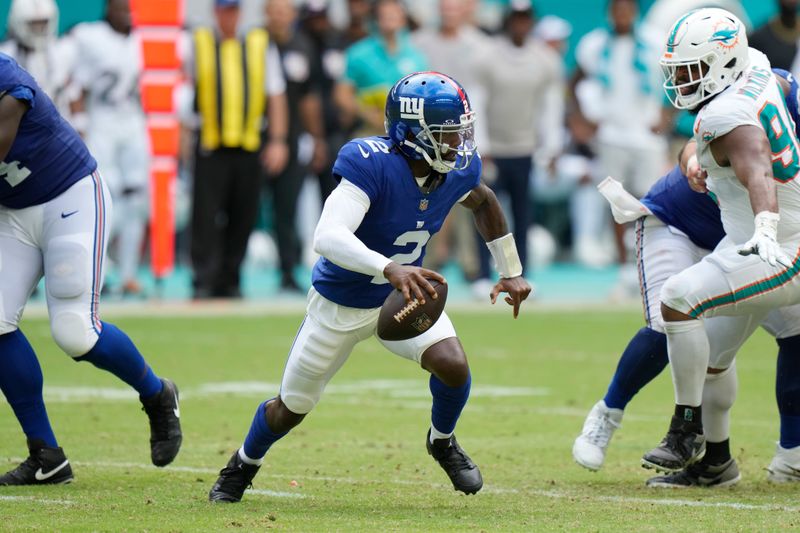 New York Giants quarterback Tyrod Taylor (2) runs with the ball during the second half of an NFL football game against the Miami Dolphins, Sunday, Oct. 8, 2023, in Miami Gardens, Fla. (AP Photo/Wilfredo Lee)