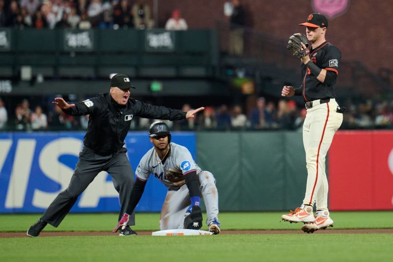 Aug 31, 2024; San Francisco, California, USA; Second base umpire Ryan Blakney (36) calls Miami Marlins infielder Otto Lopez (61) safe at second base against San Francisco Giants infielder Tyler Fitzgerald (49) during the seventh inning at Oracle Park. Mandatory Credit: Robert Edwards-USA TODAY Sports