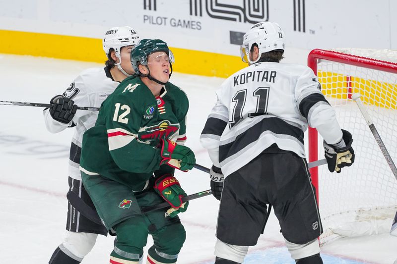 Nov 5, 2024; Saint Paul, Minnesota, USA; Los Angeles Kings center Anze Kopitar (11) sticks Minnesota Wild left wing Matt Boldy (12) in the third period at Xcel Energy Center. Mandatory Credit: Brad Rempel-Imagn Images