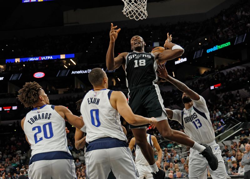 SAN ANTONIO, TX - MARCH 10: Bismack Biyombo #18 of the San Antonio Spurs is stripped of the ball by Naji Marshall #13 of the Dallas Mavericks in the second half at Frost Bank Center on March 10, 2025 in San Antonio, Texas. NOTE TO USER: User expressly acknowledges and agrees that, by downloading and or using this photograph, User is consenting to terms and conditions of the Getty Images License Agreement. (Photo by Ronald Cortes/Getty Images)