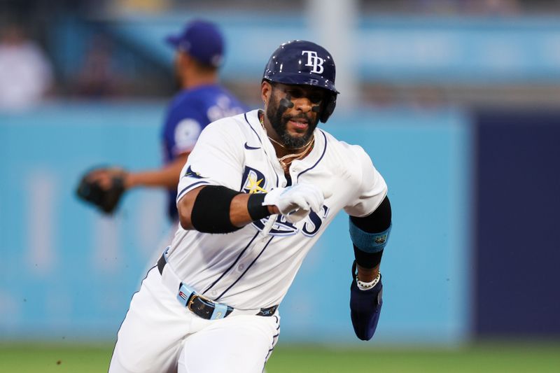 Jun 3, 2025; Tampa, Florida, USA; Tampa Bay Rays designated hitter Yandy Diaz (2) runs to third base against the Texas Rangers in the first inning at George M. Steinbrenner Field. Mandatory Credit: Nathan Ray Seebeck-Imagn Images