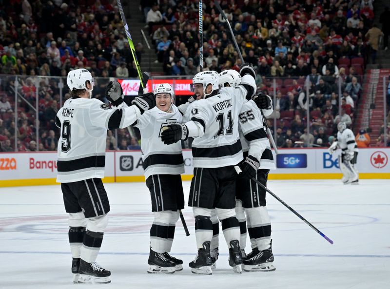 Oct 17, 2024; Montreal, Quebec, CAN; Los Angeles Kings defenseman Andreas Englund (5) celebrates with teammates including forward Anze Kopitar (11) and forward Adrian Kempe (9) after scoring a goal against the Montreal Canadiens during the third period at the Bell Centre. Mandatory Credit: Eric Bolte-Imagn Images