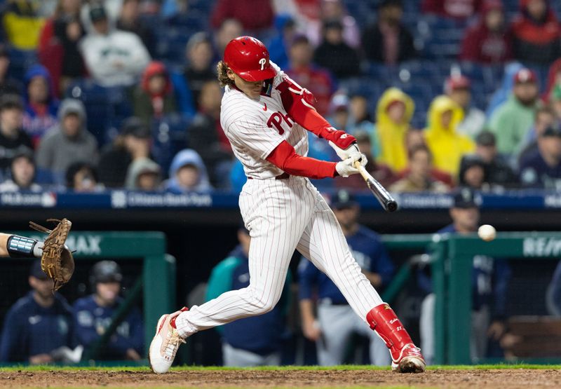 Apr 26, 2023; Philadelphia, Pennsylvania, USA; Philadelphia Phillies first baseman Alec Bohm (28) hits an RBI single during the eighth inning against the Seattle Mariners  at Citizens Bank Park. Mandatory Credit: Bill Streicher-USA TODAY Sports