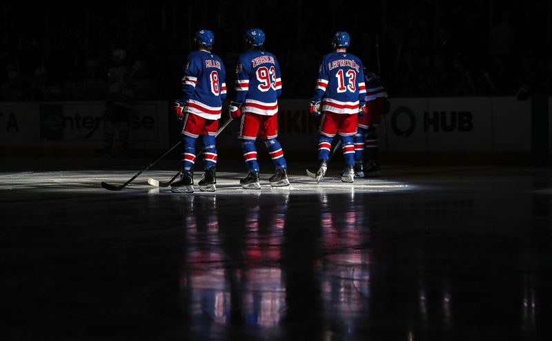 Mar 16, 2025; New York, New York, USA; New York Rangers center J.T. Miller (8), center Mika Zibanejad (93) left wing Alexis Lafreniere (13) line up for the national anthem during the first period against the Edmonton Oilers  at Madison Square Garden. Mandatory Credit: Danny Wild-Imagn Images