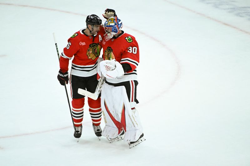 Mar 3, 2025; Chicago, Illinois, USA;  Chicago Blackhawks defenseman Alec Martinez (25) hugs goaltender Spencer Knight after the third period against the Los Angeles Kings  at the United Center. Mandatory Credit: Matt Marton-Imagn Images
