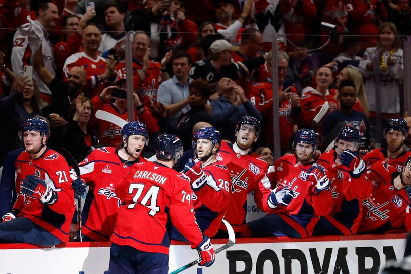 May 8, 2025; Washington, District of Columbia, USA; Washington Capitals defenseman John Carlson (74) celebrates with teammates after scoring a goal against the Carolina Hurricanes in the third period in game two of the second round of the 2025 Stanley Cup Playoffs at Capital One Arena. Mandatory Credit: Geoff Burke-Imagn Images