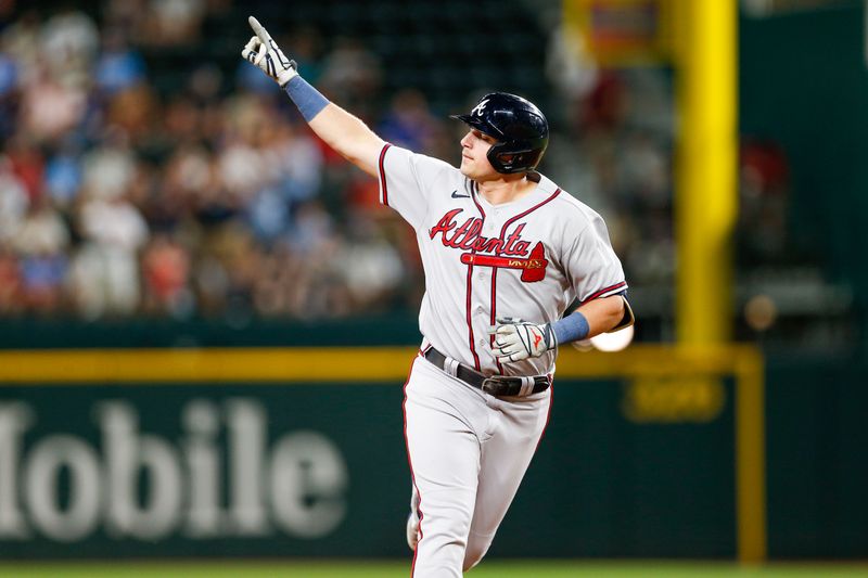 May 15, 2023; Arlington, Texas, USA; Atlanta Braves third baseman Austin Riley (27) points as he circles the bases after hitting a two-run home run during the seventh inning against the Texas Rangers at Globe Life Field. Mandatory Credit: Andrew Dieb-USA TODAY Sports