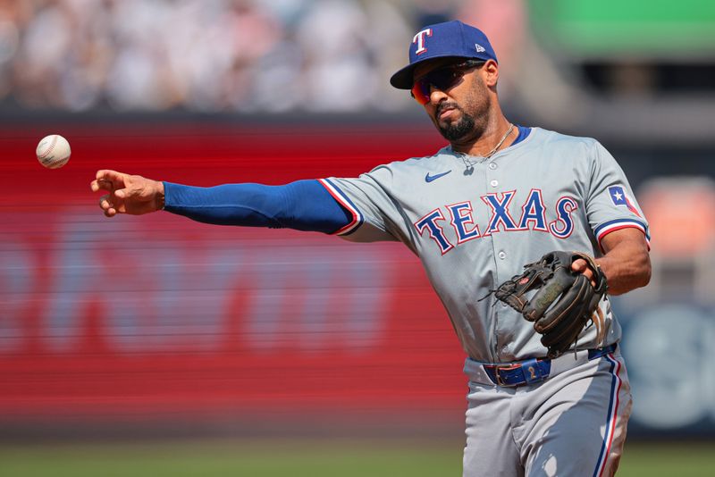 Aug 11, 2024; Bronx, New York, USA; Texas Rangers second baseman Marcus Semien (2) throws the ball to first base for an out during the third inning against the New York Yankees at Yankee Stadium. Mandatory Credit: Vincent Carchietta-USA TODAY Sports