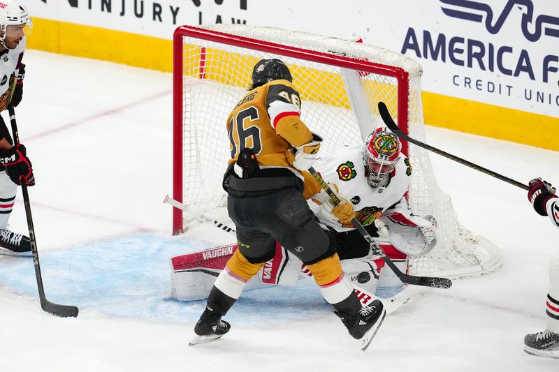 Apr 16, 2024; Las Vegas, Nevada, USA; Chicago Blackhawks goaltender Petr Mrazek (34) makes a save against Vegas Golden Knights right wing Jonas Rondbjerg (46) during the third period at T-Mobile Arena. Mandatory Credit: Stephen R. Sylvanie-USA TODAY Sports