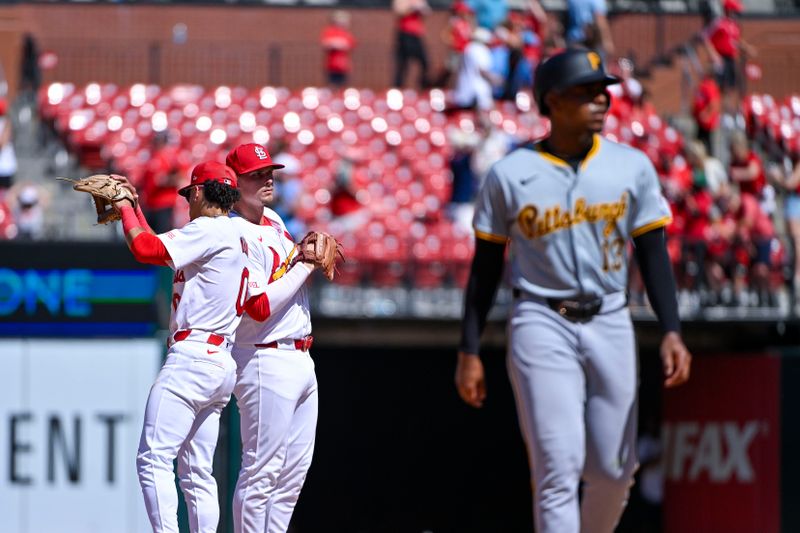 Jun 13, 2024; St. Louis, Missouri, USA;  St. Louis Cardinals second baseman Nolan Gorman (16) celebrates with shortstop Masyn Winn (0) as Pittsburgh Pirates third baseman Ke'Bryan Hayes (13) walks off the Filed after the Cardinals defeated the Pirates at Busch Stadium. Mandatory Credit: Jeff Curry-USA TODAY Sports