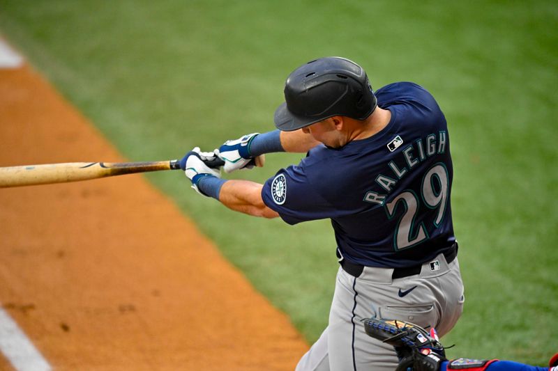 Apr 23, 2024; Arlington, Texas, USA; Seattle Mariners catcher Cal Raleigh (29) hits a two run home run against the Texas Rangers during the first inning at Globe Life Field. Mandatory Credit: Jerome Miron-USA TODAY Sports