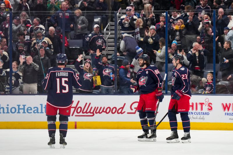 Nov 29, 2024; Columbus, Ohio, USA;  Columbus Blue Jackets right wing Kirill Marchenko (86) celebrates with teammates after scoring an empty net goal against the Calgary Flames in the third period at Nationwide Arena. Mandatory Credit: Aaron Doster-Imagn Images