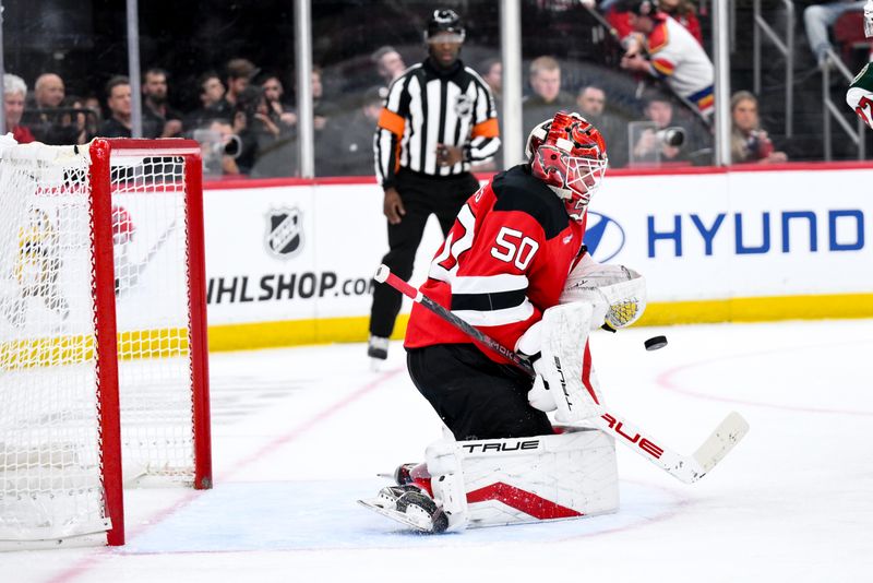 Oct 22, 2025; Newark, New Jersey, USA; New Jersey Devils goaltender Nico Daws (50) makes a save against the Minnesota Wild during the third period at Prudential Center. Mandatory Credit: John Jones-Imagn Images