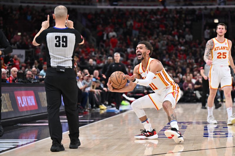 CHICAGO, ILLINOIS - APRIL 17:  Trae Young #11 of the Atlanta Hawks reacts after referee Tyler Ford #39 called him for a foul on Young in the second half against the Chicago Bulls on April 17, 2024 at United Center in Chicago, Illinois. Chicago defeated Atlanta 131-116.   NOTE TO USER: User expressly acknowledges and agrees that, by downloading and or using this photograph, User is consenting to the terms and conditions of the Getty Images License Agreement.  (Photo by Jamie Sabau/Getty Images)