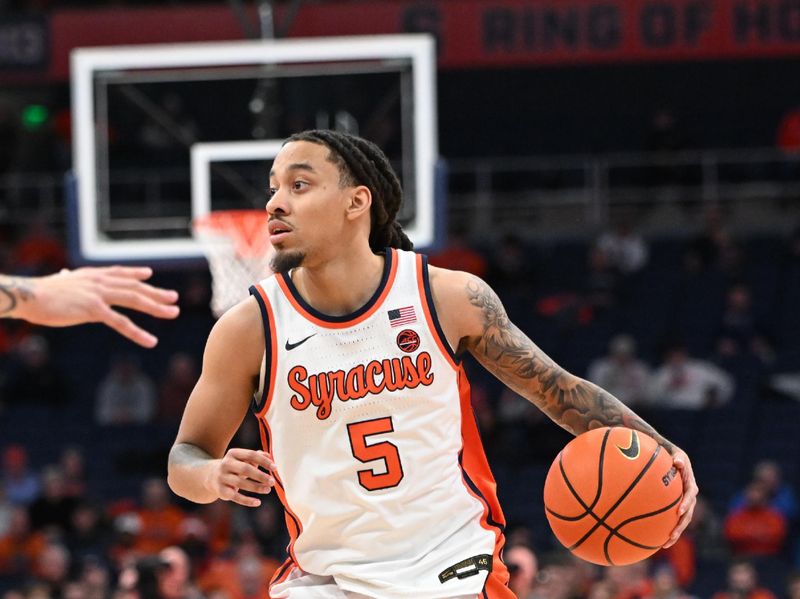 Jan 7, 2025; Syracuse, New York, USA; Syracuse Orange guard Jaquan Carlos (5) handles the ball against the Georgia Tech Yellow Jackets in the second half at the JMA Wireless Dome. Mandatory Credit: Mark Konezny-Imagn Images