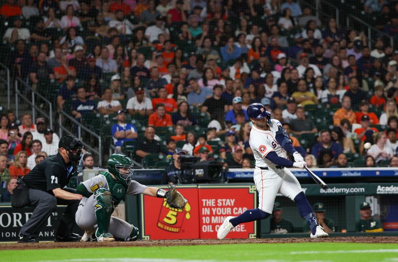 May 27, 2025; Houston, Texas, USA; Houston Astros first baseman Christian Walker (8) hits a two-run home run against the Athletics in the sixth inning at Daikin Park. Mandatory Credit: Thomas Shea-Imagn Images