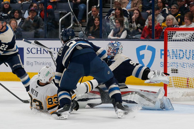 Nov 15, 2024; Columbus, Ohio, USA; Pittsburgh Penguins left wing Matt Nieto (83) crashes into Columbus Blue Jackets goalie Elvis Merzlikins (90) during the second period at Nationwide Arena. Mandatory Credit: Russell LaBounty-Imagn Images