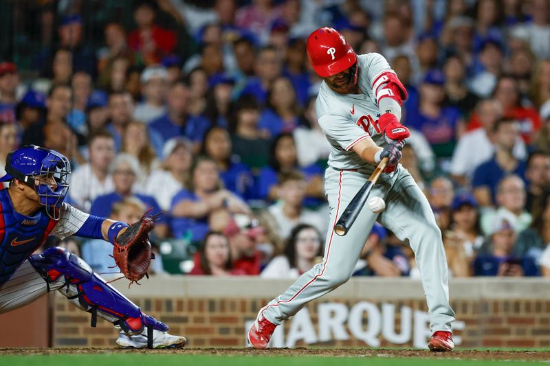 Jul 3, 2024; Chicago, Illinois, USA; Philadelphia Phillies outfielder Whit Merrifield (9) hits an RBI-single against the Chicago Cubs during the eight inning at Wrigley Field. Mandatory Credit: Kamil Krzaczynski-USA TODAY Sports