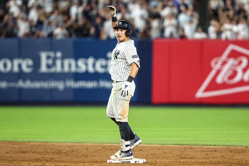 Jun 19, 2024; Bronx, New York, USA;  New York Yankees shortstop Anthony Volpe (11) reacts after hitting a double in the ninth inning against the Baltimore Orioles at Yankee Stadium. Mandatory Credit: Wendell Cruz-USA TODAY Sports