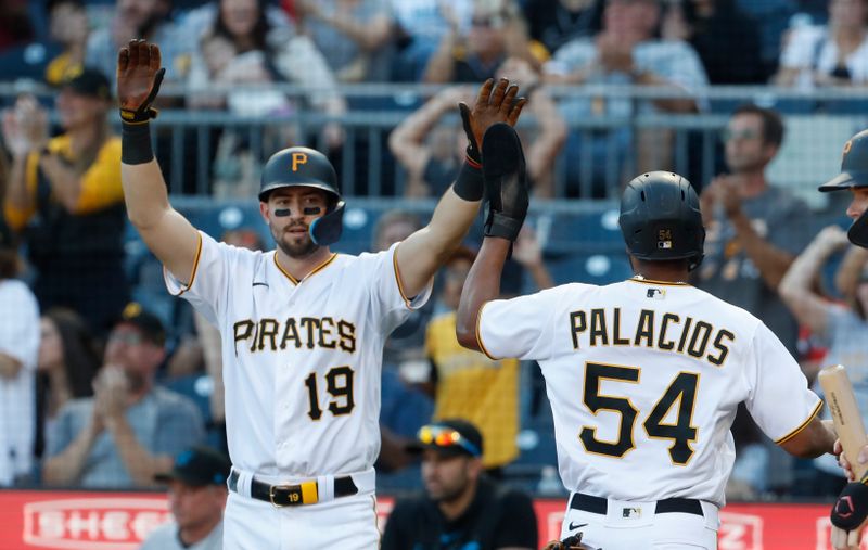 Oct 1, 2023; Pittsburgh, Pennsylvania, USA;  Pittsburgh Pirates third baseman Jared Triolo (19) and pinch runner Joshua Palacios (54) high five after both players scored runs against the Miami Marlins during the eighth inning at PNC Park. Pittsburgh won 3-0. Mandatory Credit: Charles LeClaire-USA TODAY Sports