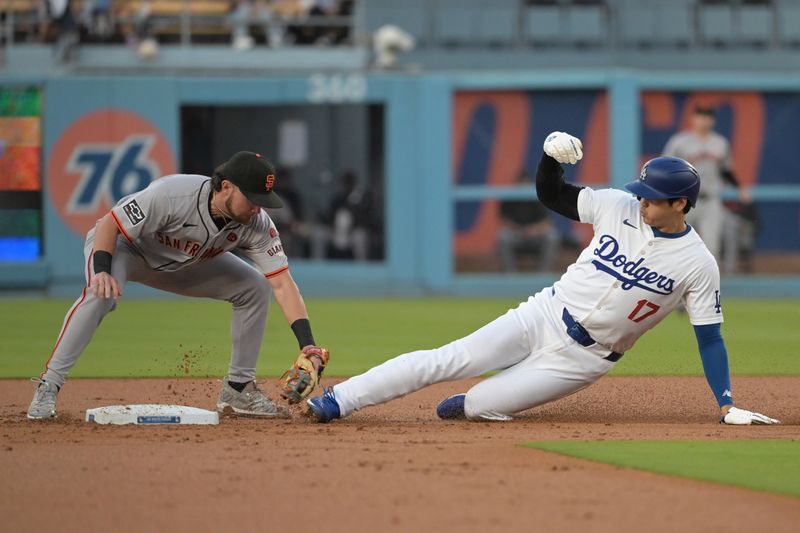 Jul 22, 2024; Los Angeles, California, USA;  Los Angeles Dodgers designated hitter Shohei Ohtani (17) is caught stealing on a tag by San Francisco Giants shortstop Brett Wisely (0) in the first inning at Dodger Stadium. Mandatory Credit: Jayne Kamin-Oncea-USA TODAY Sports