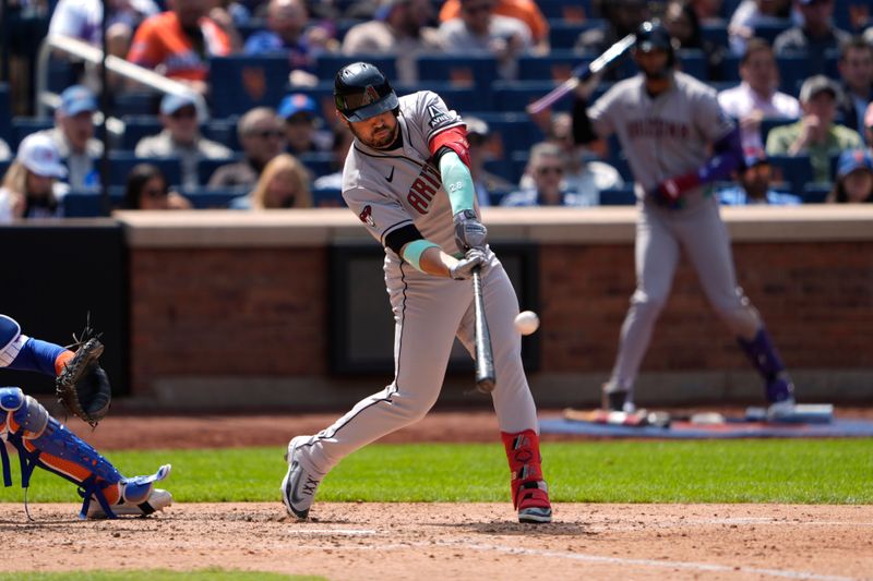 May 1, 2025; New York City, New York, USA; Arizona Diamondbacks third baseman Eugenio Suarez (28) hits a sacrifice fly ball against the New York Mets during the fifth inning at Citi Field. Mandatory Credit: Gregory Fisher-Imagn Images