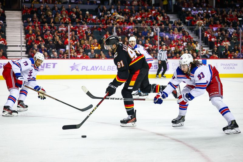 Nov 21, 2024; Calgary, Alberta, CAN; Calgary Flames center Nazem Kadri (91) controls the puck against New York Rangers center Mika Zibanejad (93) during the second period at Scotiabank Saddledome. Mandatory Credit: Sergei Belski-Imagn Images