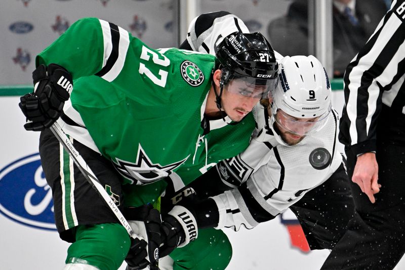 Jan 16, 2024; Dallas, Texas, USA; Los Angeles Kings right wing Adrian Kempe (9) is hit in the face by a puck during the face-off as Dallas Stars left wing Mason Marchment (27) battles for position during the first period at the American Airlines Center. Mandatory Credit: Jerome Miron-USA TODAY Sports