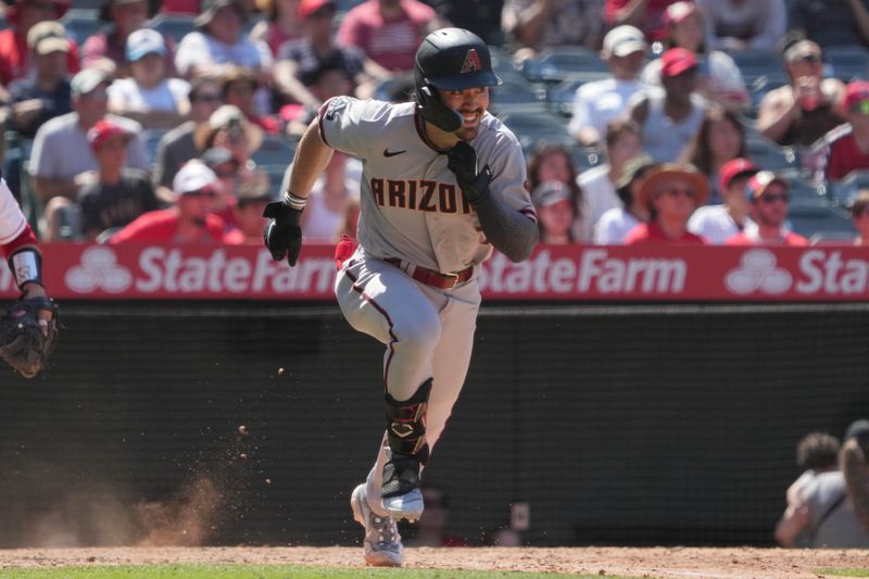 Jul 2, 2023; Anaheim, California, USA; Arizona Diamondbacks left fielder Corbin Carroll (7) runs to first base on a single in the ninth inning against the Los Angeles Angels at Angel Stadium. Mandatory Credit: Kirby Lee-USA TODAY Sports