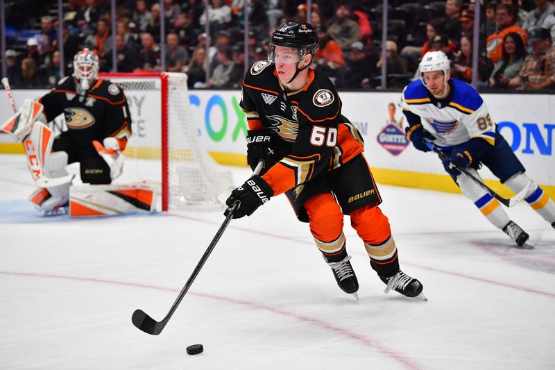 Apr 7, 2024; Anaheim, California, USA; Anaheim Ducks defenseman Jackson LaCombe (60) moves the puck against the St. Louis Blues during the first period at Honda Center. Mandatory Credit: Gary A. Vasquez-USA TODAY Sports