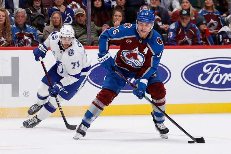 Oct 30, 2024; Denver, Colorado, USA; Colorado Avalanche right wing Mikko Rantanen (96) controls the puck ahead of Tampa Bay Lightning center Anthony Cirelli (71) in the second period at Ball Arena. Mandatory Credit: Isaiah J. Downing-Imagn Images