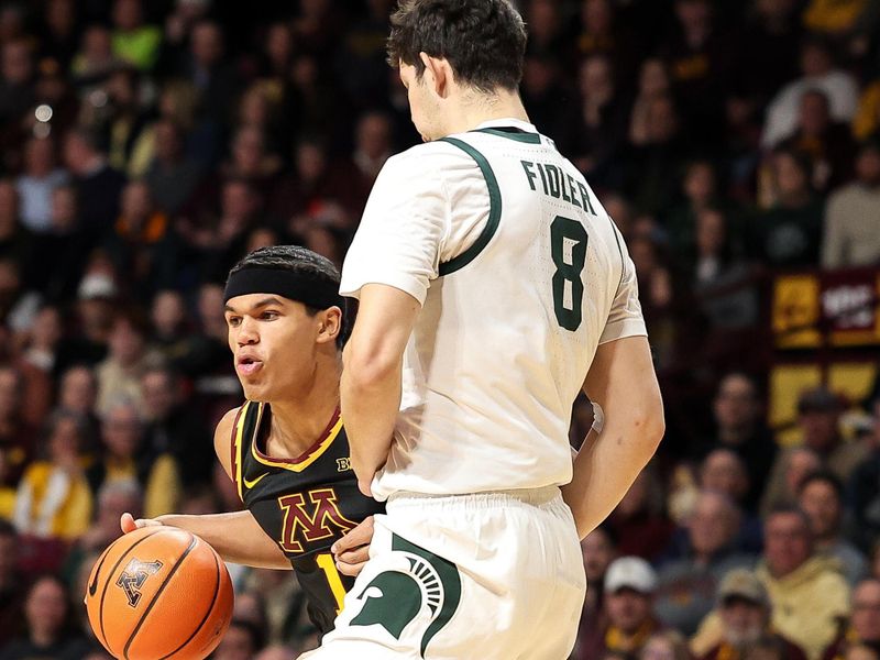 Dec 4, 2024; Minneapolis, Minnesota, USA; Minnesota Golden Gophers guard Isaac Asuma (1) works around Michigan State Spartans forward Frankie Fidler (8) during the first half at Williams Arena. Mandatory Credit: Matt Krohn-Imagn Images