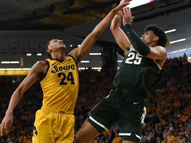 Feb 25, 2023; Iowa City, Iowa, USA; Michigan State Spartans forward Malik Hall (25) shoots the ball over Iowa Hawkeyes forward Kris Murray (24) during the first half at Carver-Hawkeye Arena. Mandatory Credit: Jeffrey Becker-USA TODAY Sports