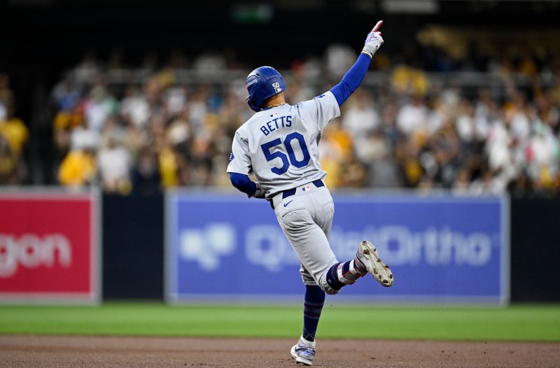 Oct 9, 2024; San Diego, California, USA; Los Angeles Dodgers shortstop Mookie Betts (50) celebrates after hitting a home run in the first inning against the San Diego Padres during game four of the NLDS for the 2024 MLB Playoffs at Petco Park.  Mandatory Credit: Denis Poroy-Imagn Images