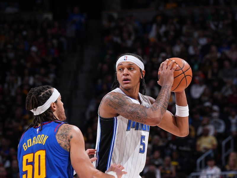 DENVER, CO - JANUARY 5: Paolo Banchero #5 of the Orlando Magic handles the ball during the game against the Denver Nuggets on January 5, 2024 at the Ball Arena in Denver, Colorado. NOTE TO USER: User expressly acknowledges and agrees that, by downloading and/or using this Photograph, user is consenting to the terms and conditions of the Getty Images License Agreement. Mandatory Copyright Notice: Copyright 2024 NBAE (Photo by Garrett Ellwood/NBAE via Getty Images)