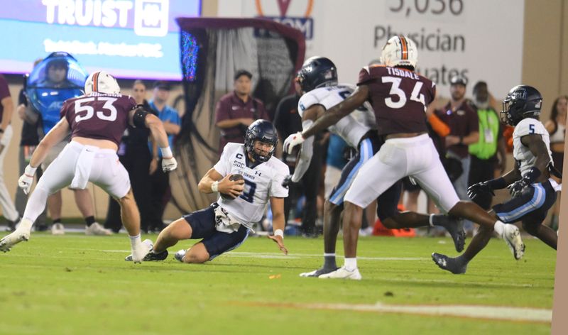 Sep 2, 2023; Blacksburg, Virginia, USA; Old Dominion Monarchs quarterback Grant Wilson (13) slides after a gain against the Virginia Tech Hokies in the third quarter at Lane Stadium. Mandatory Credit: Lee Luther Jr.-USA TODAY Sports