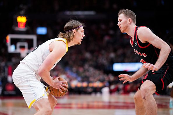 TORONTO, ON - DECEMBER 23: Kelly Olynyk #41 of the Utah Jazz is guarded by Jakob Poeltl #19 of the Toronto Raptors during the second half of their basketball game at the Scotiabank Arena on December 23, 2023 in Toronto, Ontario, Canada. NOTE TO USER: User expressly acknowledges and agrees that, by downloading and/or using this Photograph, user is consenting to the terms and conditions of the Getty Images License Agreement. (Photo by Mark Blinch/Getty Images)