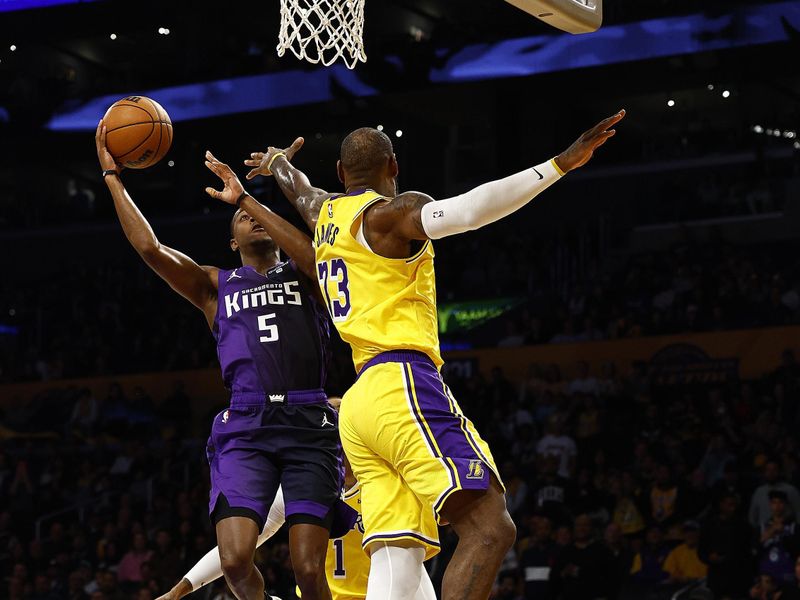 LOS ANGELES, CALIFORNIA - NOVEMBER 15:  De'Aaron Fox #5 of the Sacramento Kings takes a shot against LeBron James #23 of the Los Angeles Lakers in the first quarter at Crypto.com Arena on November 15, 2023 in Los Angeles, California.  NOTE TO USER: User expressly acknowledges and agrees that, by downloading and/or using this photograph, user is consenting to the terms and conditions of the Getty Images License Agreement. (Photo by Ronald Martinez/Getty Images)