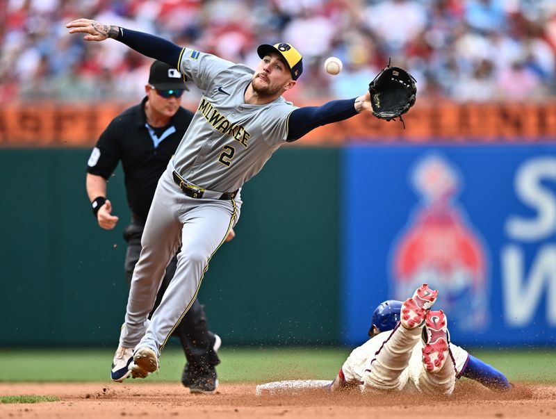 Jun 5, 2024; Philadelphia, Pennsylvania, USA; Philadelphia Phillies second baseman Bryson Stott (5) steals second base under Milwaukee Brewers infielder Brice Turang (2) in the sixth inning at Citizens Bank Park. Mandatory Credit: Kyle Ross-USA TODAY Sports