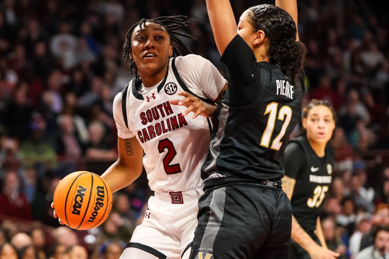 Jan 28, 2024; Columbia, South Carolina, USA; South Carolina Gamecocks forward Ashlyn Watkins (2) drives around Vanderbilt Commodores forward Khamil Pierre (12) in the first half at Colonial Life Arena. Mandatory Credit: Jeff Blake-USA TODAY Sports