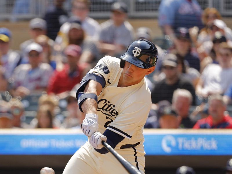 Apr 13, 2025; Minneapolis, Minnesota, USA; Minnesota Twins third baseman Brooks Lee (2) hits an RBI single against the Detroit Tigers in the second inning at Target Field. Mandatory Credit: Bruce Kluckhohn-Imagn Images