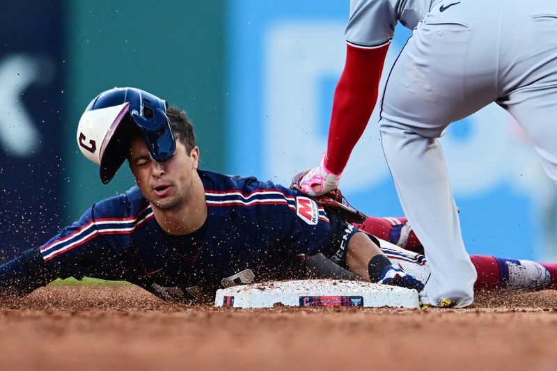 May 31, 2024; Cleveland, Ohio, USA; Cleveland Guardians center fielder Tyler Freeman (2) advances to second under the tag of Washington Nationals second baseman Luis Garcia Jr. (2) on an RBI single that scored Guardians shortstop Brayan Rocchio (not pictured) during the third inning at Progressive Field. Mandatory Credit: Ken Blaze-USA TODAY Sports